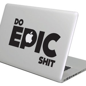 May include: A silver laptop with a black sticker that says "DO EPIC SHIT" with an Apple logo in the middle of the word "EPIC".