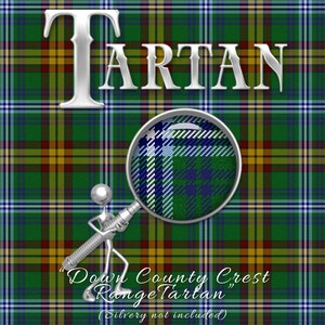 May include: A close-up of a green, yellow, and red tartan fabric with the word "TARTAN" in silver letters. A magnifying glass is pointing to a section of the fabric, showing a closer view of the pattern. The text "Down County Crest Range Tartan" is written below the image, with the words "Silvery not included" in parentheses.