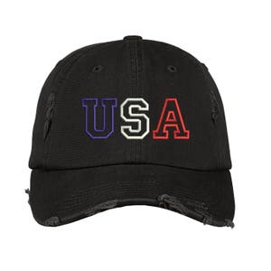 May include: A black distressed baseball cap with the word "USA" embroidered in red, white, and blue.