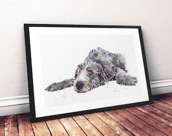 May include: Watercolor painting of a grey dog lying down, framed in black. The dog has a long snout and floppy ears, with a soft, textured appearance. The artwork is displayed against a white background.