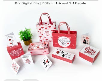 May include: Printable Valentine's Day craft kit featuring boxes, bags, and cards. The kit includes a variety of designs with hearts, flowers, and the words "Love is in the Air" and "Happy Valentine's Day".
