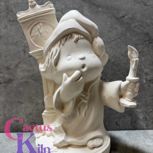 May include: A bisque ceramic figurine of a child in a nightcap and gown, holding a candle and standing next to a clock. The figurine is unpainted and ready for customization. The base is round, and the clock shows the time.