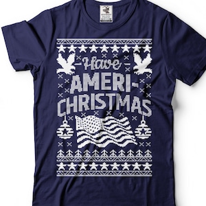 May include: A navy blue t-shirt with a white knit design featuring an American flag, eagles, and the text "I Have Ameri-Christmas".