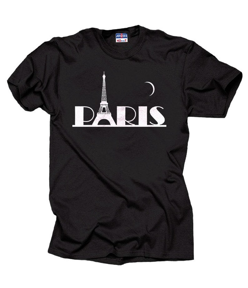 May include: Black t-shirt with a white graphic of the Eiffel Tower and the word "PARIS" with a crescent moon above the tower.