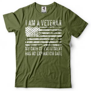May include: Green t-shirt with a white distressed American flag and the text "I am a Veteran. My oath of enlistment has no expiration date."
