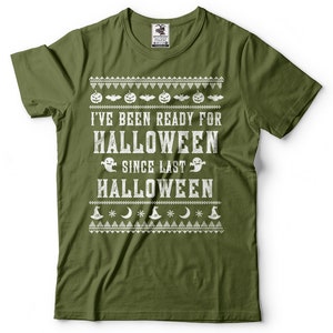 May include: A green t-shirt with a white graphic print that says "I've been ready for Halloween since last Halloween". The graphic includes pumpkins, bats, ghosts, and stars.
