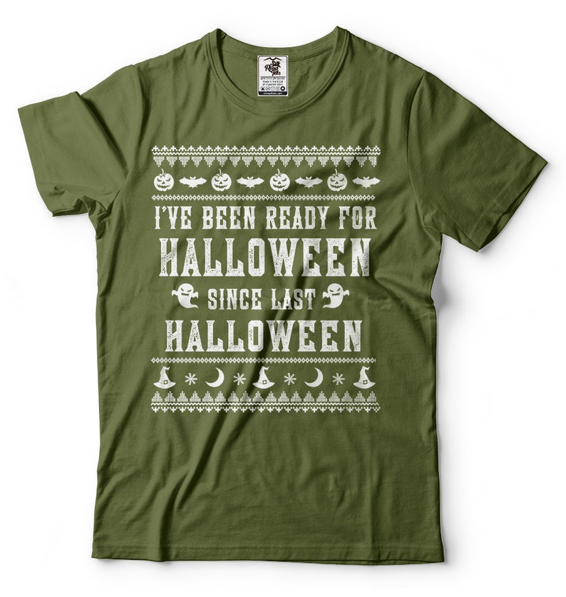 May include: A green t-shirt with a white graphic print that says "I've been ready for Halloween since last Halloween". The graphic includes pumpkins, bats, ghosts, and stars.