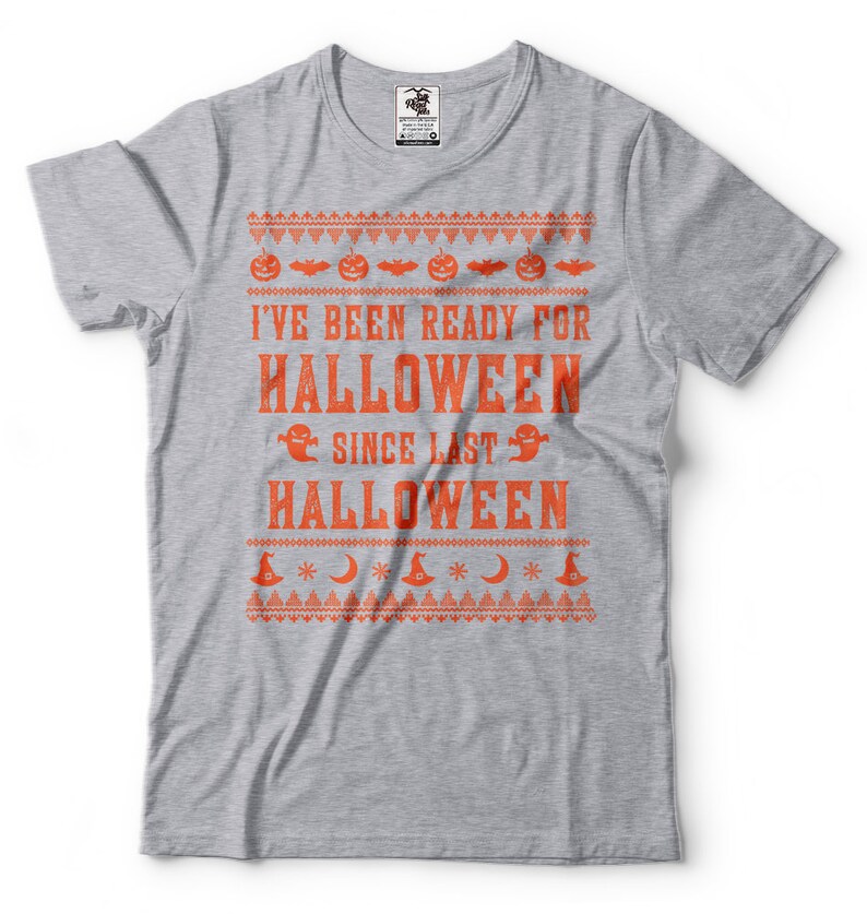 May include: Grey t-shirt with an orange print that says "I've been ready for Halloween since last Halloween". The print has a festive, Christmas jumper-like design with pumpkins, bats, ghosts, and stars.