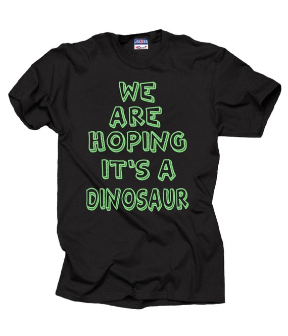 We're Hoping It's A Dinosaur Pregnancy Graphic T-Shirt We're Hoping It's A Dinosaur Pregnancy Graphic T-Shirt