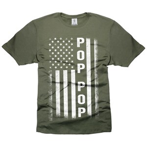 May include: A green t-shirt with a white distressed American flag design and the word "POP" vertically down the right side of the flag.
