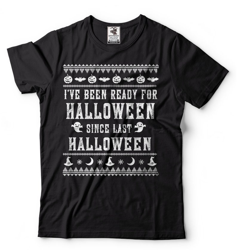 May include: Black t-shirt with a white graphic print that says "I've been ready for Halloween since last Halloween". The graphic includes pumpkins, bats, ghosts, and witch hats.