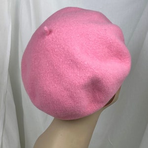 May include: A pink wool beret. The beret is soft and has a classic style.