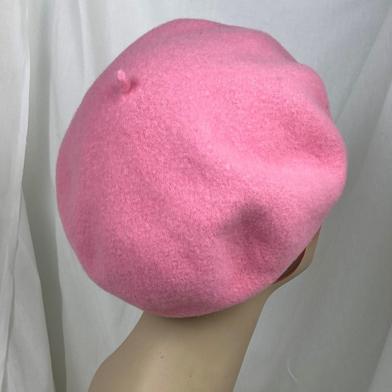 May include: A pink wool beret. The beret is soft and has a classic style.