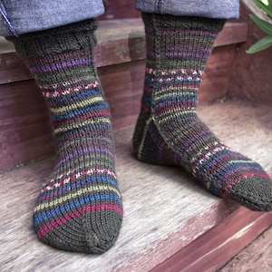 May include: A pair of striped socks in shades of green, blue, red, and purple. The socks are made of a soft, knitted fabric and have a comfortable fit.