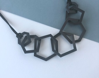 Charcoal grey modern geometric acrylic necklace.