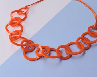Bright orange circle modern geometric acrylic chain necklace.