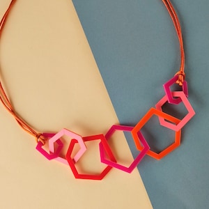 Multi shade orange and pink modern geometric acrylic necklace.