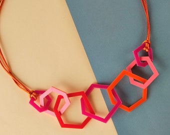 Multi shade orange and pink modern geometric acrylic necklace.