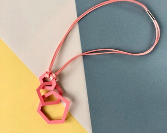 Coral pink geometric pendant necklace.