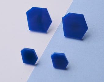 Set of large and small royal blue hexagon stud earrings.