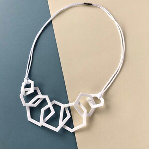 White stylish geometric mid-length acrylic necklace. image 3
