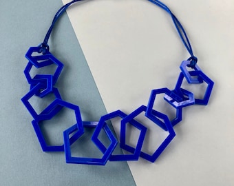 Royal blue chunky mid-length geometric acrylic necklace.