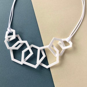 White stylish geometric mid-length acrylic necklace.