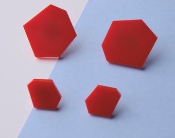 Set of large and small bright red hexagon stud earrings.