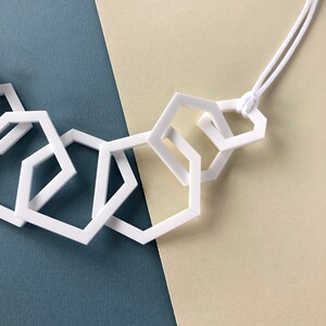 White stylish geometric mid-length acrylic necklace. image 4