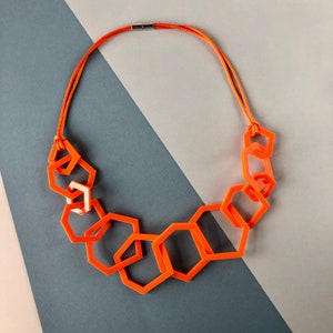 Bright orange chunky geometric statement necklace.