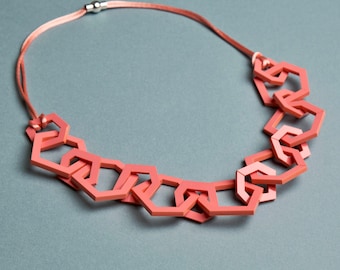 Coral pink modern geometric chain link acrylic necklace.