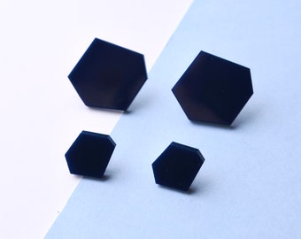Set of large and small navy blue hexagon stud earrings.
