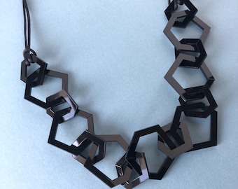 Black modern geometric chain link acrylic necklace.