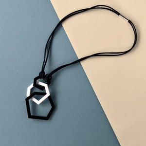 Contemporary black and white geometric pendant necklace.