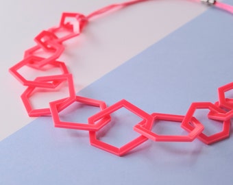 Neon pink chunky geometric statement necklace.