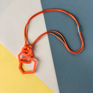 Bright orange modern geometric, acrylic pendant necklace.