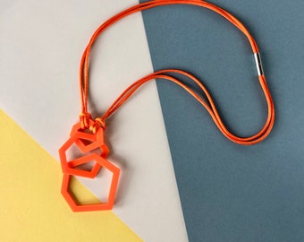 Bright orange modern geometric, acrylic pendant necklace.