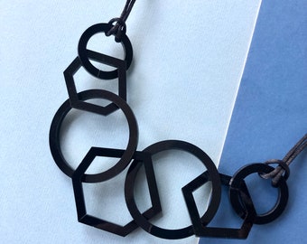 Black mid-century modern hexagon and circle geometric acrylic necklace.