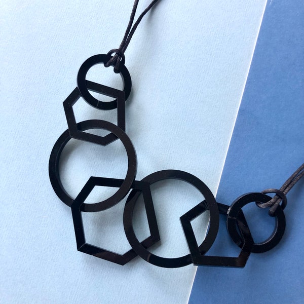 Black mid-century modern hexagon and circle geometric acrylic necklace.