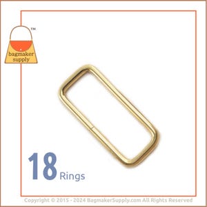 May include: Gold metal rings, 18 rings in total. The rings are rectangular in shape with rounded corners.  The rings are approximately 1 inch in length and 1/2 inch in width.