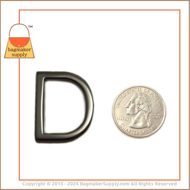 May include: A silver-toned metal D-ring, approximately the size of a US quarter. The ring is smooth and has a rounded edge.