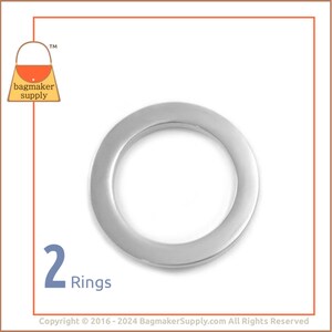 May include: A pair of silver-colored rings. The rings are circular with a smooth, reflective surface. The image includes the text "2 Rings" in blue, and a logo for "bagmaker supply".