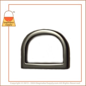 May include: A silver-toned metal D-ring hardware for bags and other crafts. The ring is smooth and has a rounded shape.