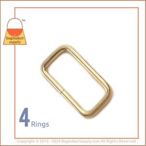 May include: Four gold-toned metal rings, each with a rectangular shape. The rings are ideal for attaching to straps or handles.