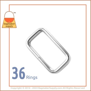 May include: A silver metal ring, 36 rings in total, for making bags and other crafts. The ring is rectangular in shape and has a smooth finish.