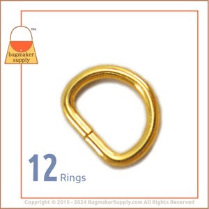 May include: A pack of 12 gold-colored metal D-rings. The rings are approximately 1 inch in diameter.  12 Rings