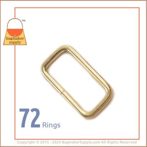 May include: A pack of 72 gold-toned metal rings. The rings are rectangular in shape and have a smooth finish. They are commonly used for attaching straps or handles to bags or other leather goods.