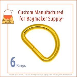 May include: Six gold-colored metal D-rings. The rings are approximately 1 inch in diameter. The image includes the text "Custom Manufactured for Bagmaker Supply™".