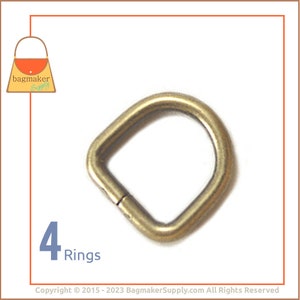 May include: A single, gold-colored D-ring for bag making. The ring is square with rounded corners and has a small opening. The image includes the text "4 Rings" in blue, and the "bagmaker supply" logo.