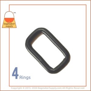 May include: A close-up of a black metal D-ring. The ring is 1 inch in diameter and is made of durable metal. It is perfect for attaching to bags, straps, or other accessories.